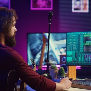 Music producer operating with electronic setup of home studio