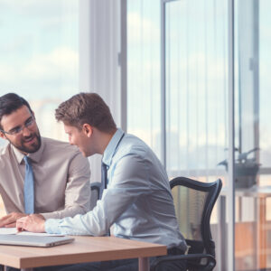 Smiling young businessmen indoors