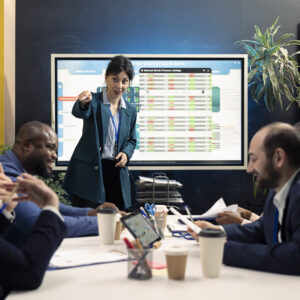 Teammates gathering in a conference room for meetings to go over their input