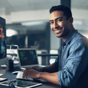 Portrait of a man using a computer in a modern office.