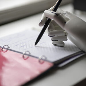 the artificial robotic arm write down some notes with pen