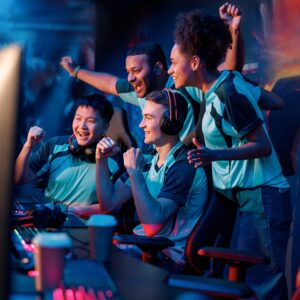 Team of professional cybersport gamers celebrating success in gaming club