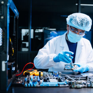 Professional electronics technician repairing computer motherboa