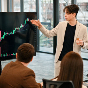 Young worker leading business meeting about cryptocurrencies in an office